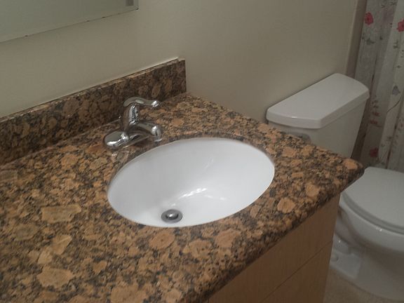 granite in baths. new tile . clean