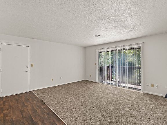 Carpeted Living Room with Large Window