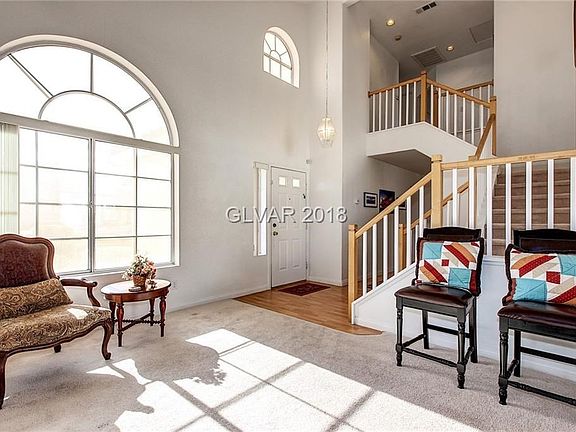 Sunny entry foyer with arched windows