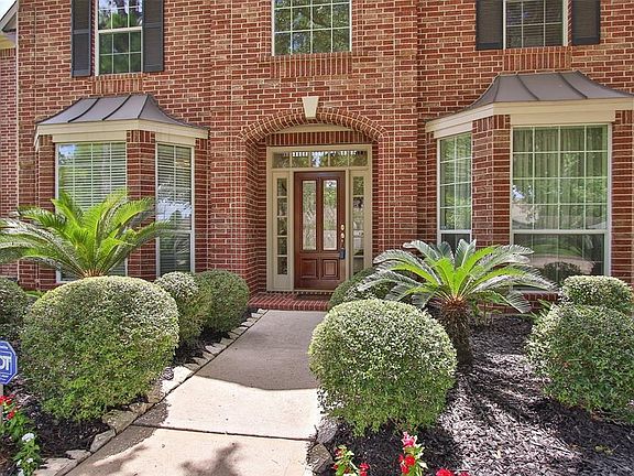 Front door with lead glass front door, sprinklers, & note the double paned windows.