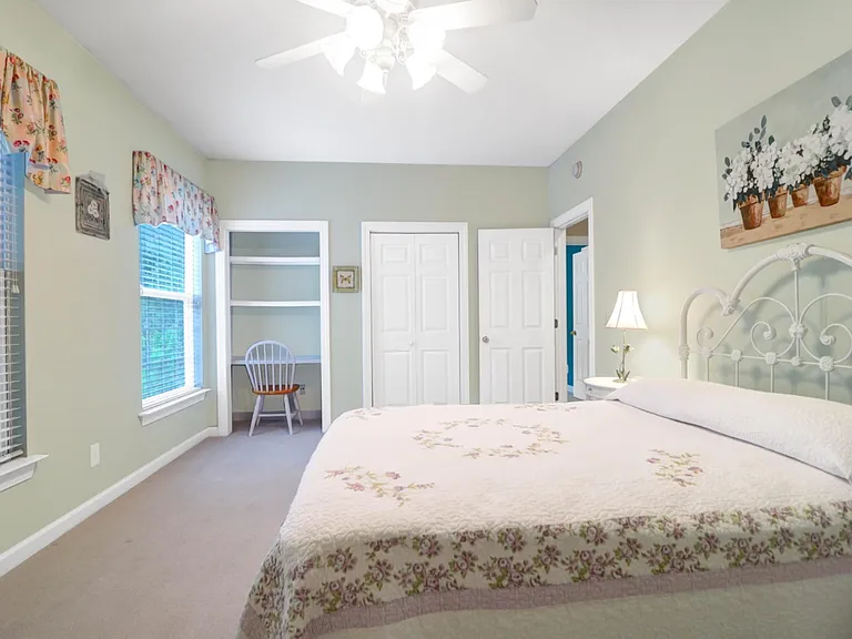 Second bedroom features a small workspace next to the clothing closet.