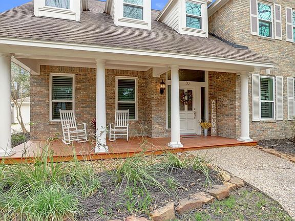 Your holiday decorations will have a perfect spot on this inviting covered front patio.