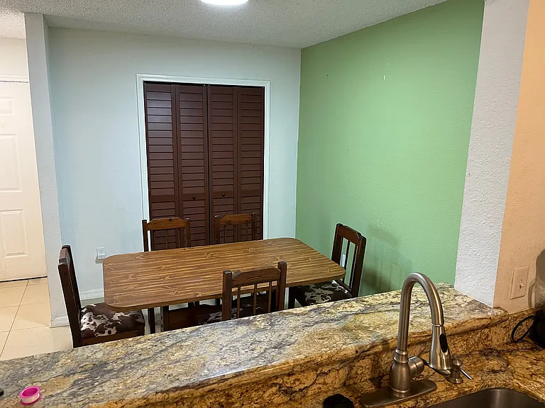 View from kitchen to dining room. Front entrance to the left of photo