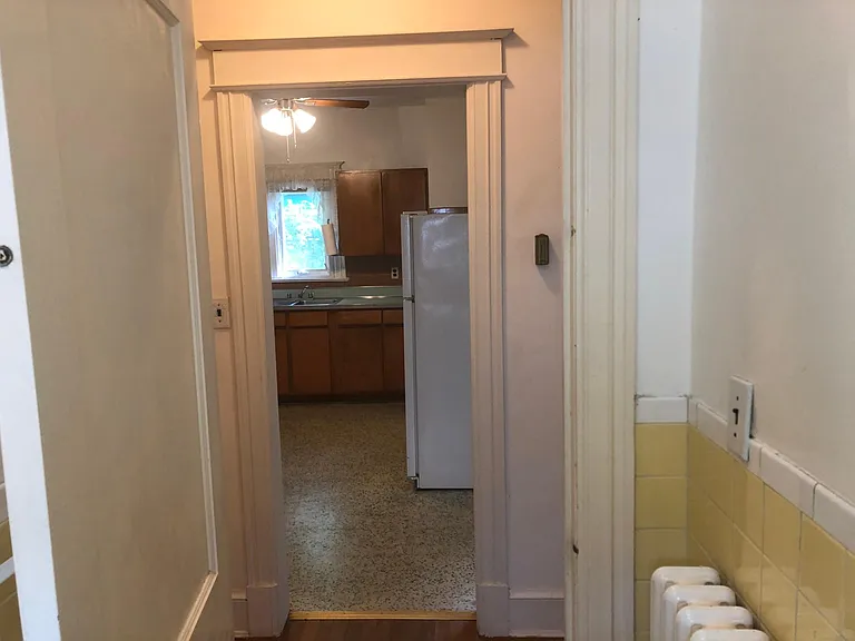 Full Bath, Ceramic Tile walls and flooring, leading to Hallway and Kitchen