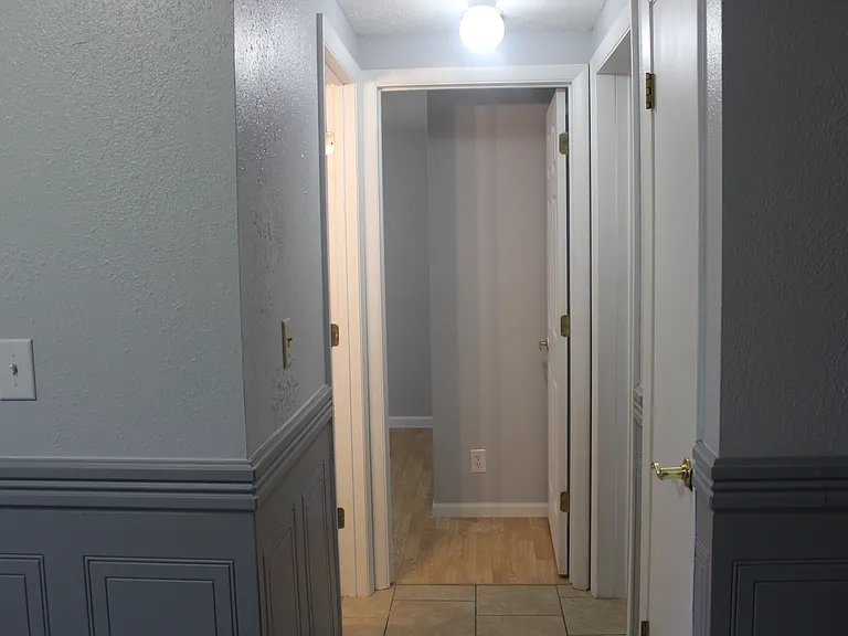 house entryway to bedrooms 1&2, bathroom 1, and linen closet