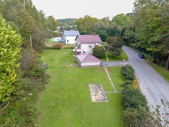 ONCE UPON A TIME THERE WAS A SHED ON THE CONCRETE PAD.  NEWERMETAL  ROOFS ON HOUSE AND GARAGE!