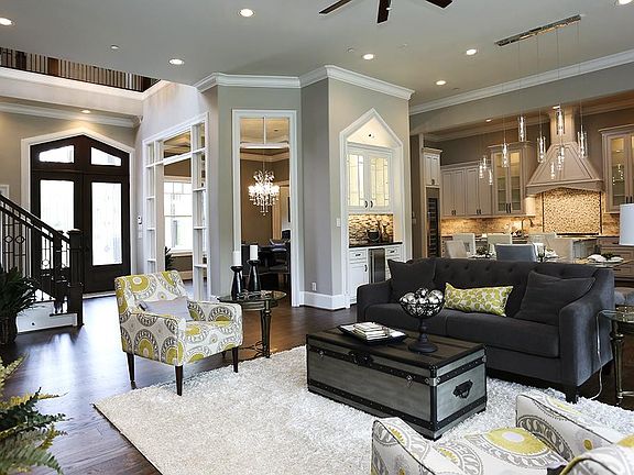 The custom entry doors reflect the Craftsman touches and the two story entry flows into the main liv