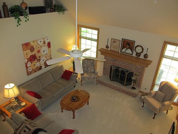 14' volume ceiling, transom windows, plant ledge and masonry wood burn fireplace