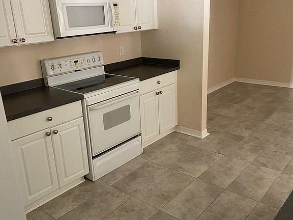 Kitchen leads to dining area and overlooks living room.