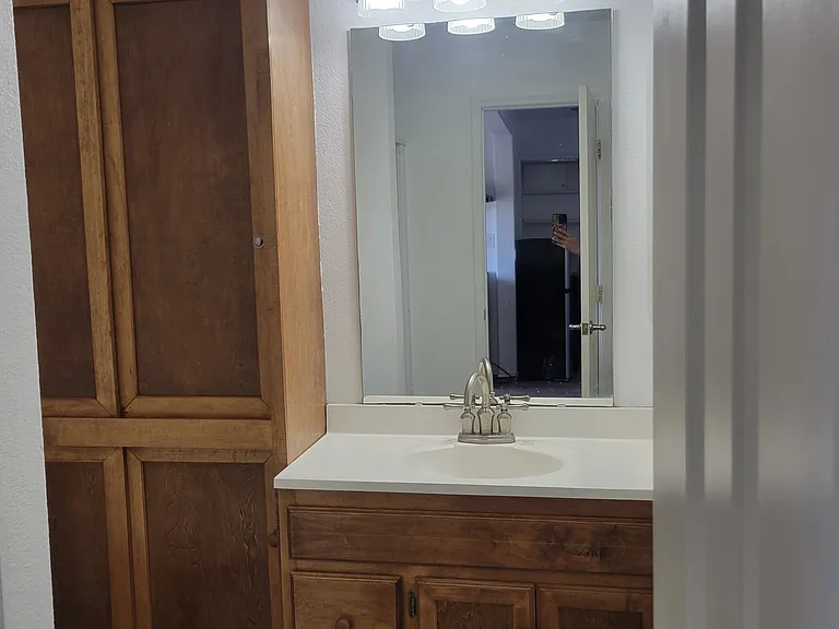 Restroom with wood storage space.