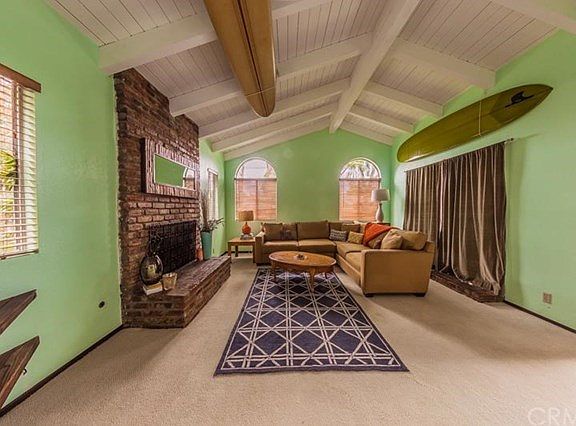 A bright and inviting family room features a beautiful fireplace