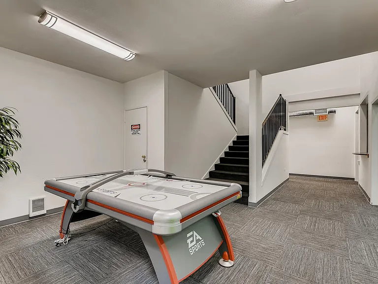 The Community Clubhouse with a Air Hockey Table at Morningtree Park Apartments