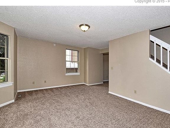 Living room with fresh paint and new carpet.