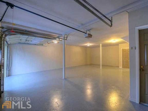 Large 2 car enclosed garage/basement with room for a workshop, wine cellar, storm room.