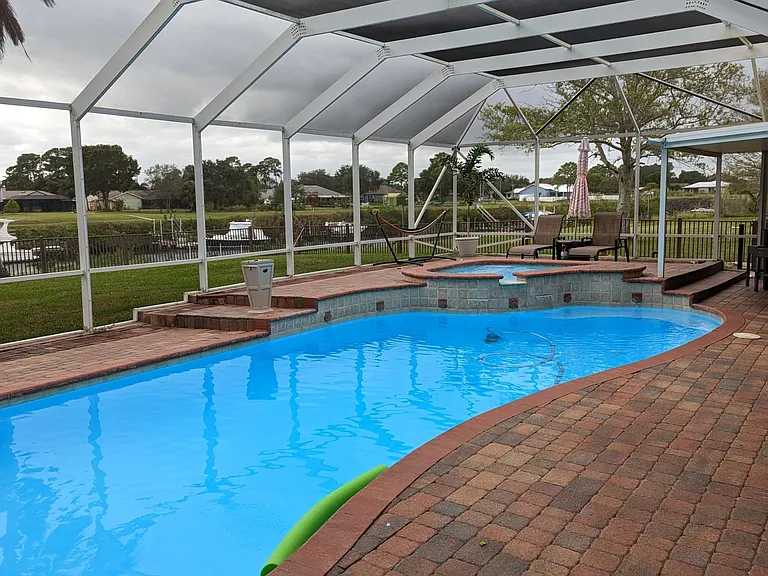 This 15,000 gallon heated pool was recently resealed and repainted. The pool includes a 13-option colorful lighting system, a vacuum, two waterfalls, a fire/fountain feature for ambiance, stairs in the shallow end, a bench in the deep end and full screen