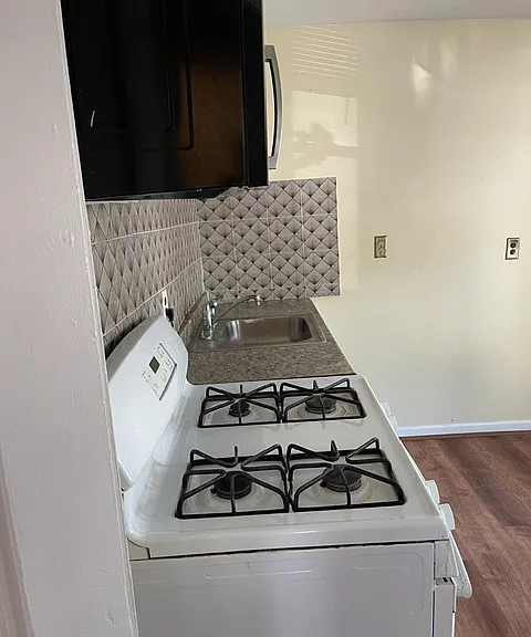 Kitchen: backsplash tiles/stove and wall mount microwave