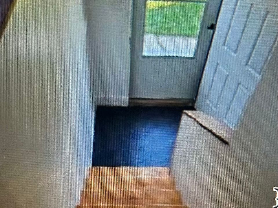 Stairs going down from the maim floor to front entry.