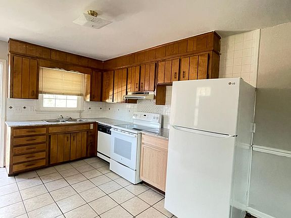 Kitchen with new fridge and granite counter tops