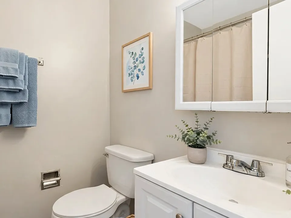 Spacious bathroom featuring ample cabinet storage and complete bathroom fixtures for added comfort and convenience