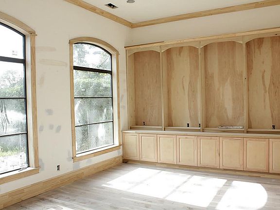 Study off of entry views front. Built in bookcases and file storage, hardwood floors, wide base molding and crown molding. Double glass doors close entry off for privacy.