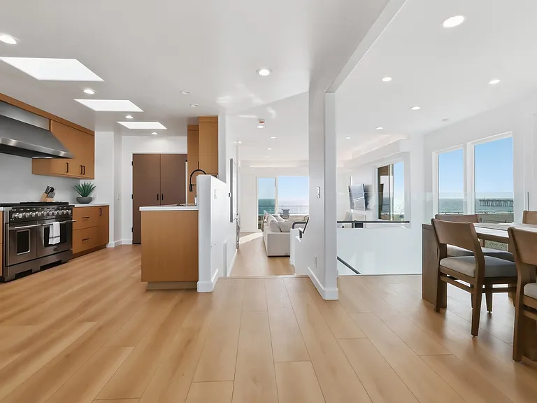 At the top of the third floor you will find a chef's kitchen with walk-in pantry, breakfast nook, 8-sit dining table, and rooftop patio with direct stair access to the street