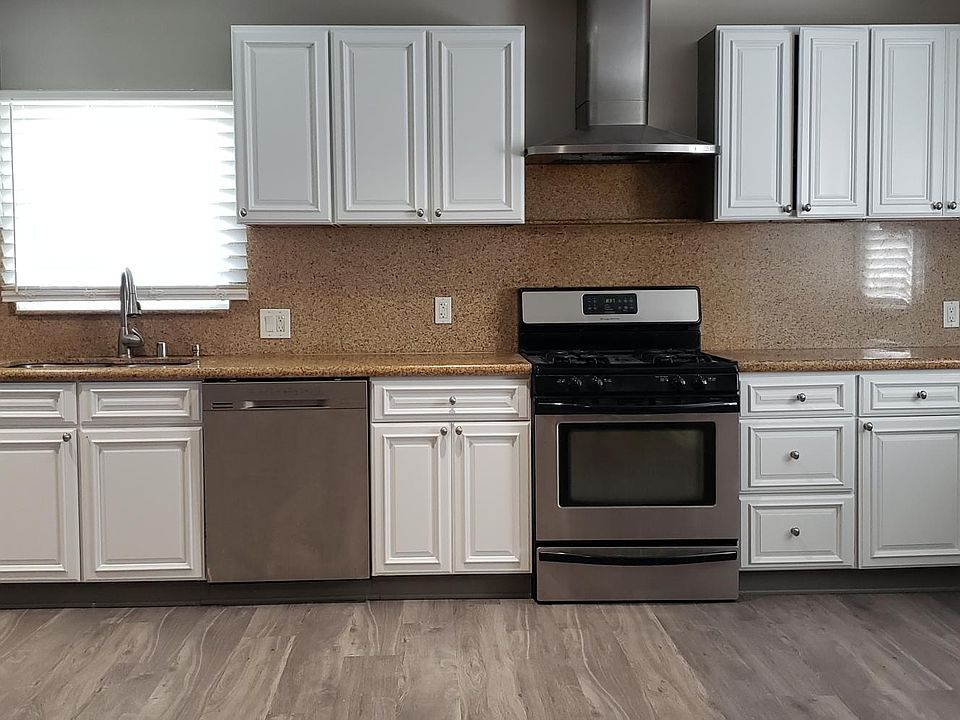 Updated kitchen with granite countertop and newly painted cabinets