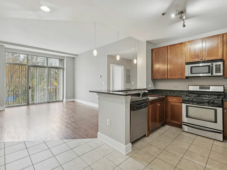 Open-concept kitchen with stainless steel appliances and bar counter