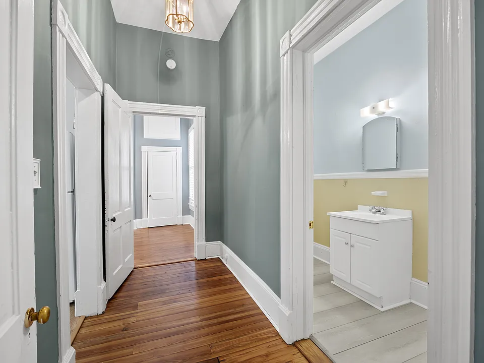 hallway from living room to bedroom, bathroom on right