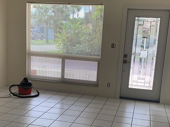 Livingroom with Impact glass window and new crystal front door. 14X17.