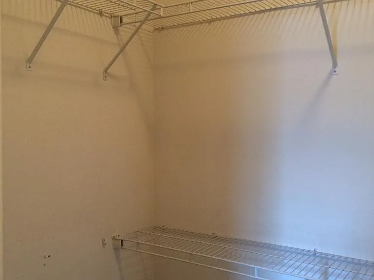 Other half of huge walk-in closet attached to Master bedroom (hard to show how big it is.).
