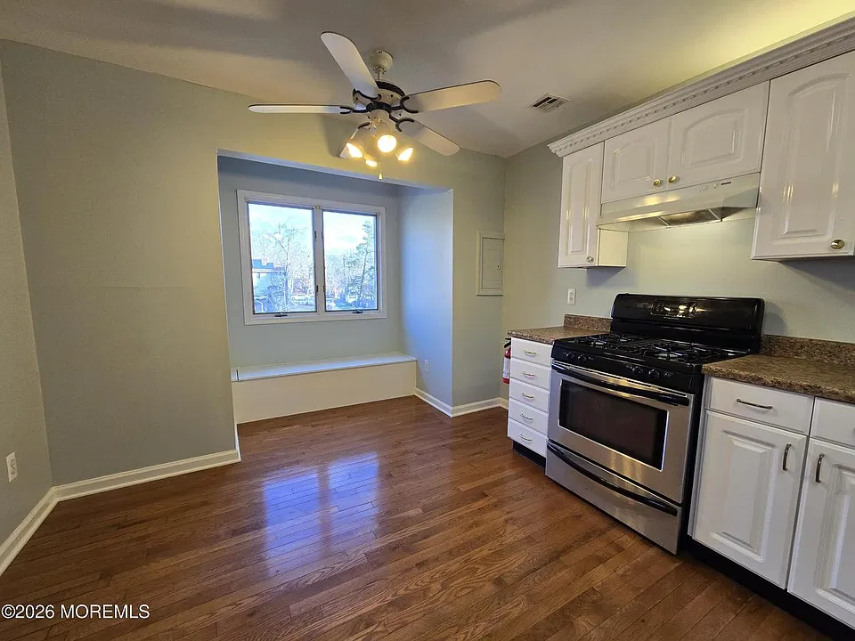 Large eat-in kitchen with plenty of cabinet storage and ceiling fan