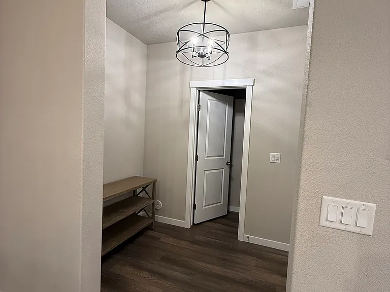 Mud room and entry way from garage. Access to half bathroom.