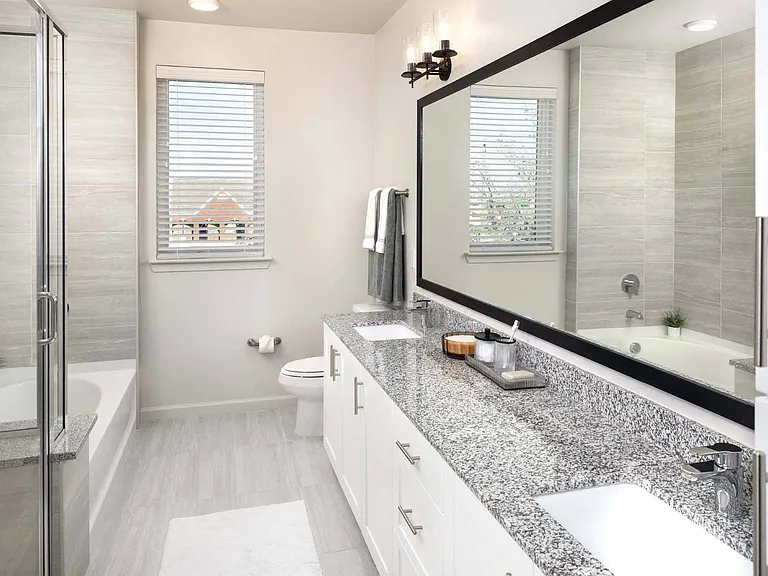 Pamper yourself in your modern bathroom, complete with dual sinks, oversized framed mirrors and a sleek vanity.