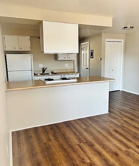 Inviting kitchen with sleek countertops, modern appliances, and elegant wood flooring in a bright, open layout.