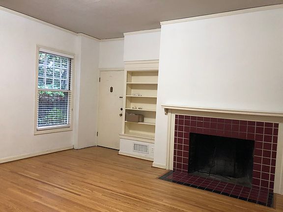 large living room, built in bookcase and fireplace