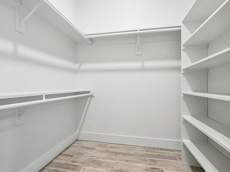 Large walk-in closet with custom shelving.