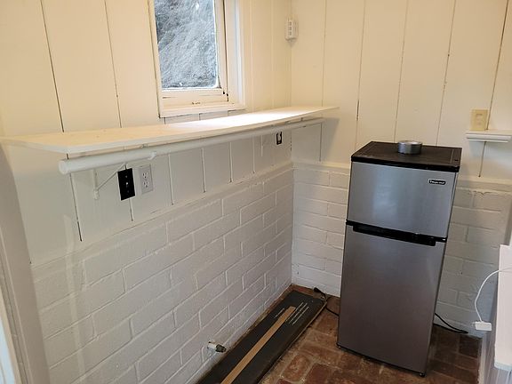 Multi-purpose entryway area often serves as a closet...okay to add shelves. One tenant fit a twin mattress in here! ...and put the frig in the main room.