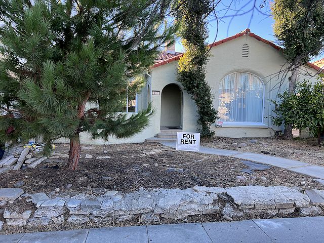 Front of House (unit is on the left behind the tree)
