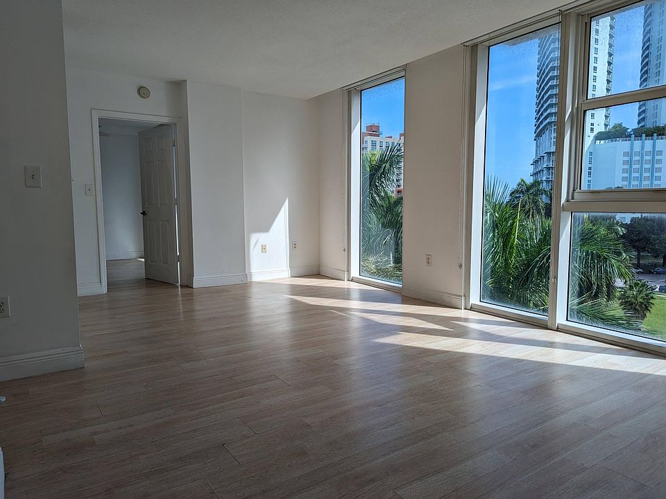 Living Room: Bright and spacious view of the city and the water - New floor will be lighter