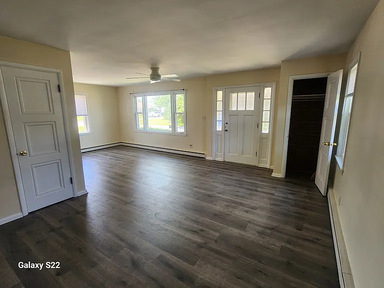 Living room area with storage closet and pantry area from dining area.
