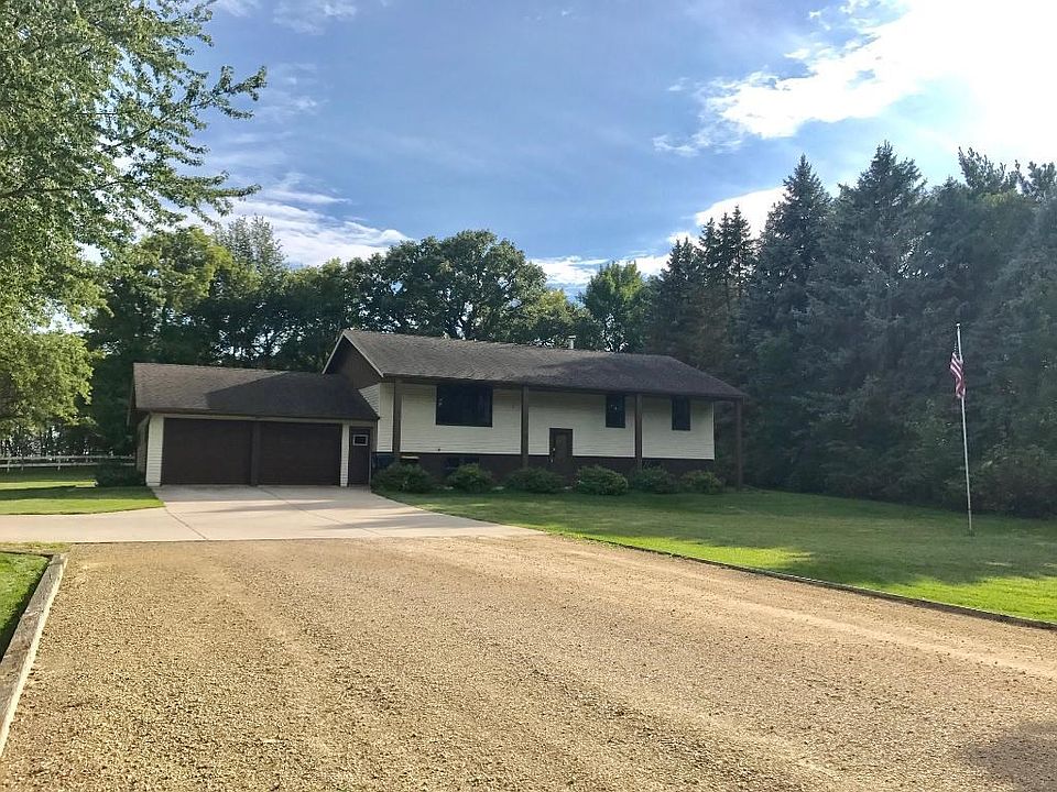 Solid split level home on 1.4 acres with concrete driveway and extra parking spaces.