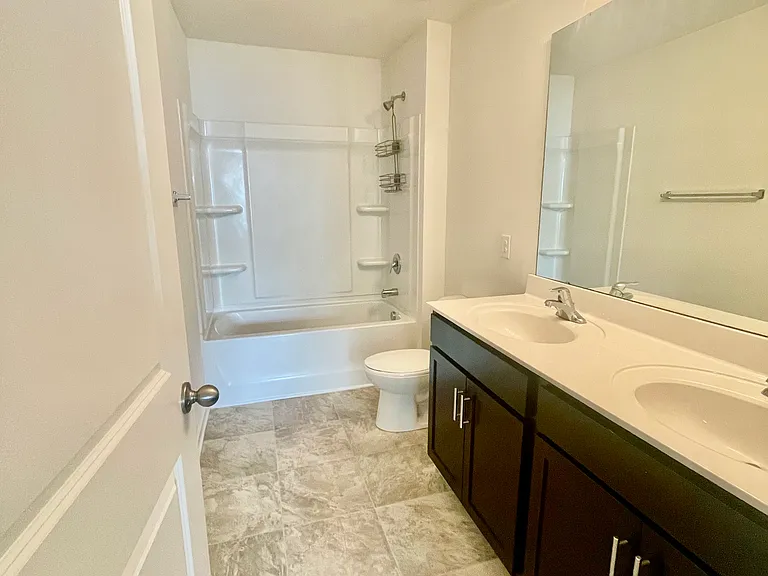 Upstairs bathroom with double sink and tub/shower