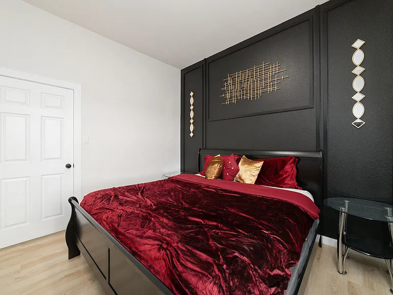 Guest bedroom from window view, King size bed, 55 inch smart TV, and private closet.