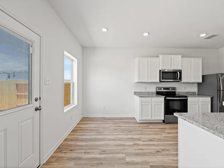 Dining space with a door to the backyard.