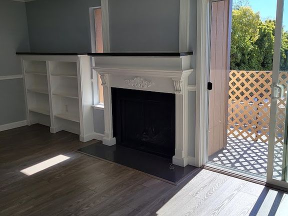 fireplace with built in bookcases and the balcony