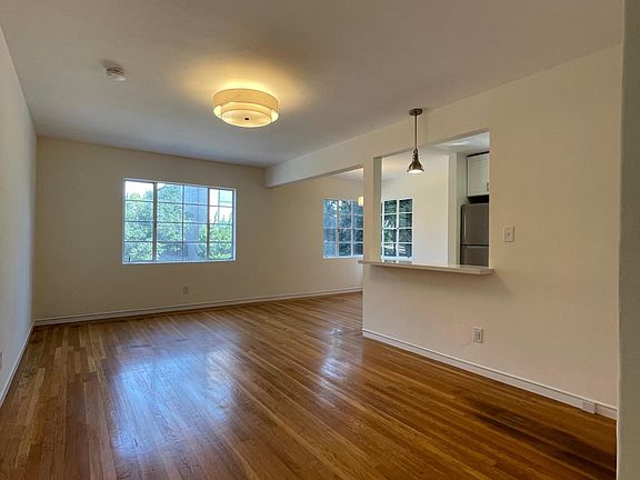 Living room and dining space with opening to kitchen