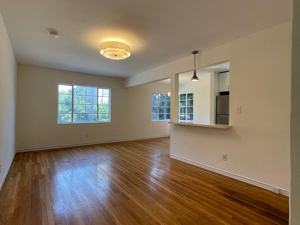 Living room and dining space with opening to kitchen