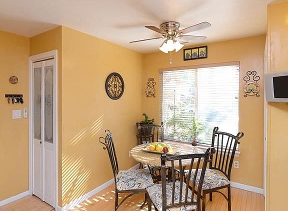 Sun filled kitchen with dining area and pantry closet.