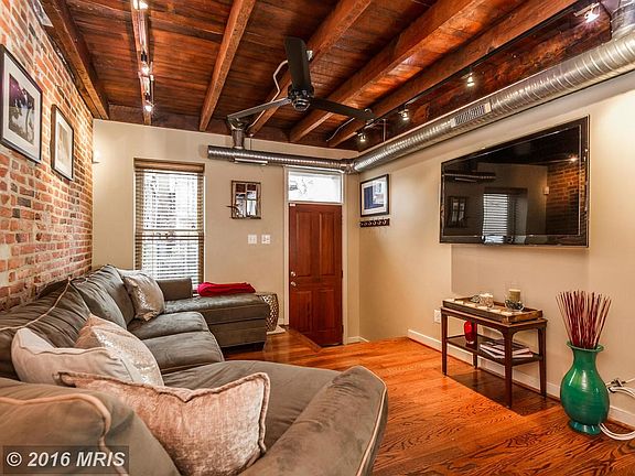 Living room features exposed duct work