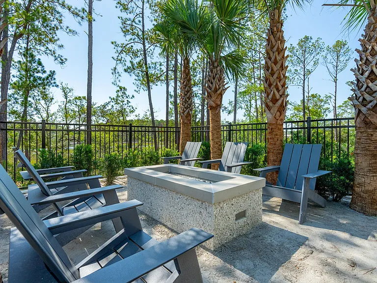 Marshfront gathering space with gas fire pit and lounge seating